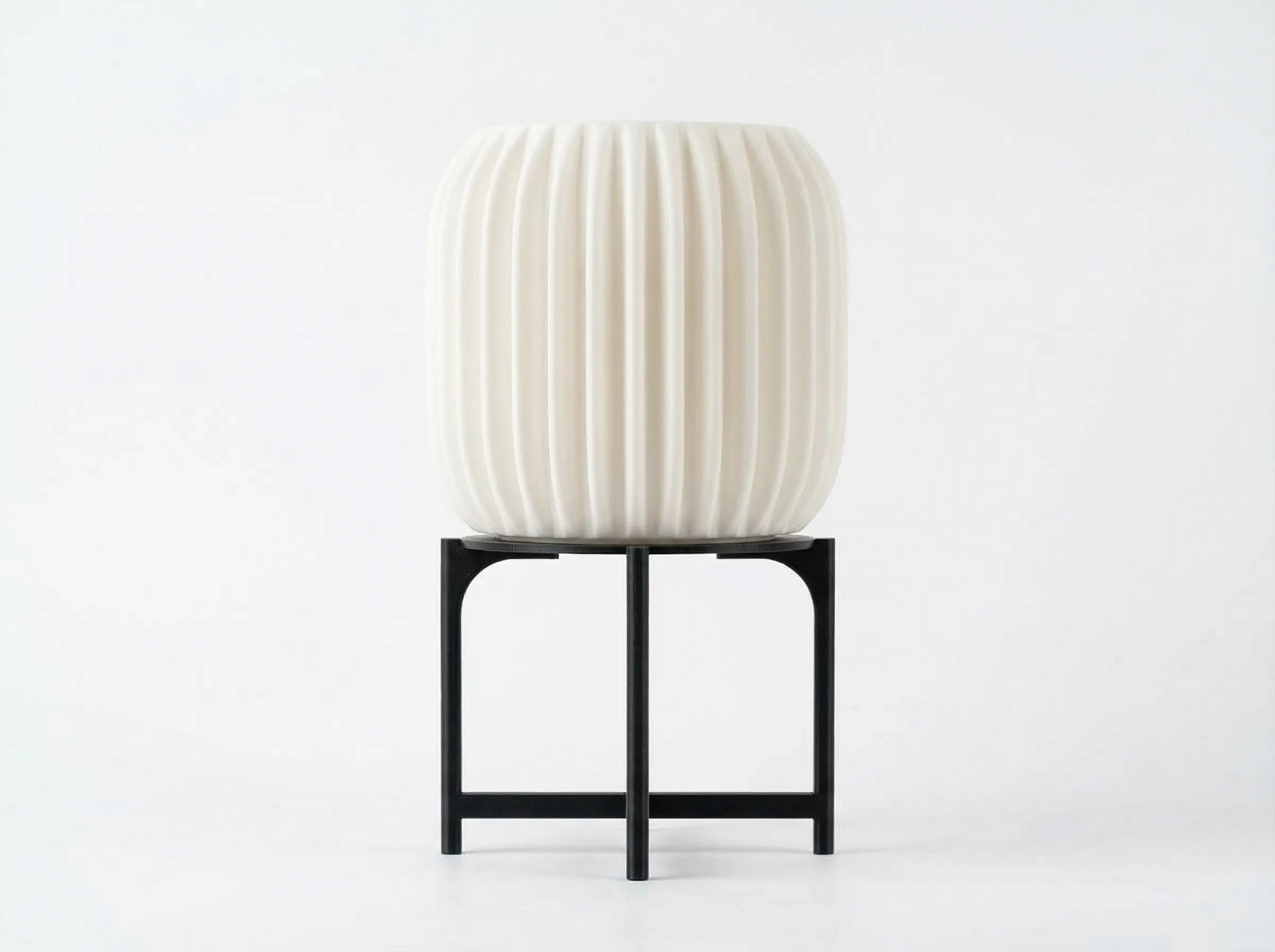The LampuKita lamp switched off, a ribbed white shade on a black stand
